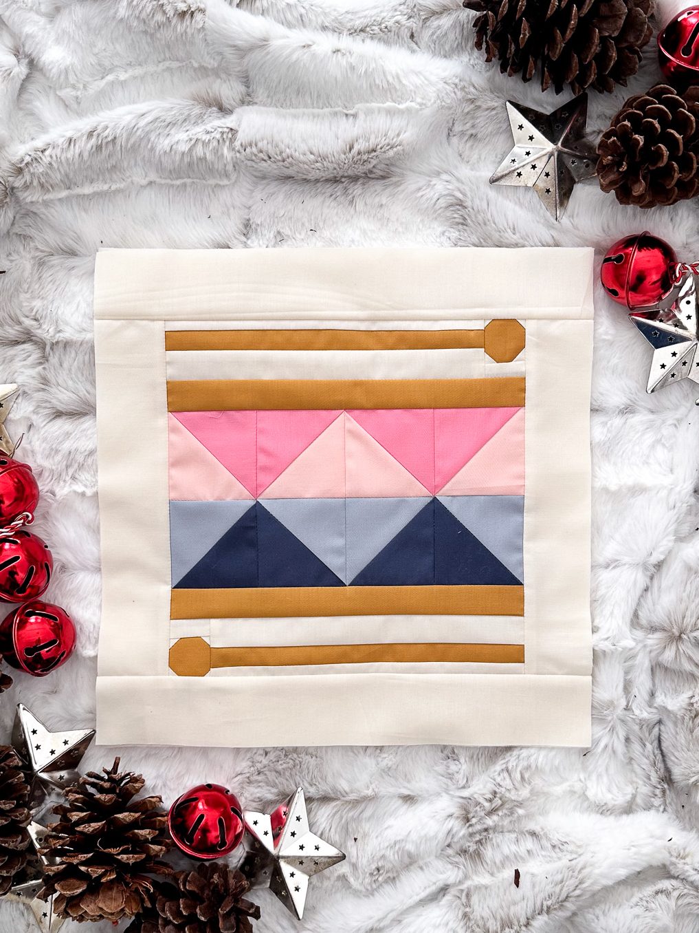 A drum kit of pink and blue with wooden drum sticks.